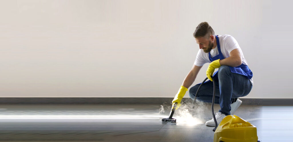 Professional cleaner steam cleaning office floor