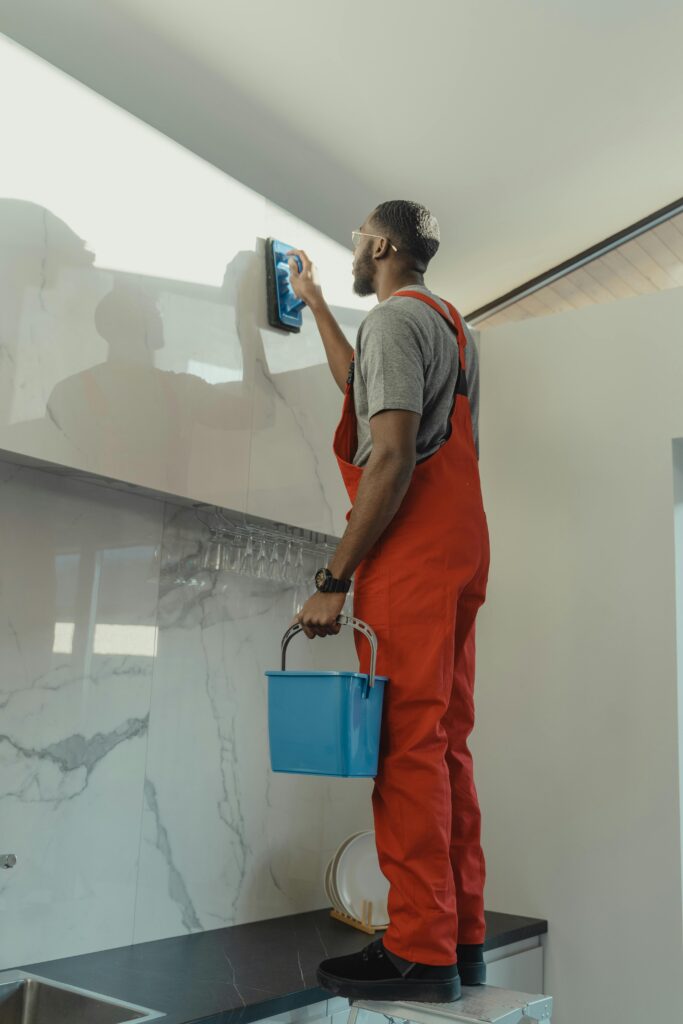 Real photo of a handyman fixing something in a Dubai apartment